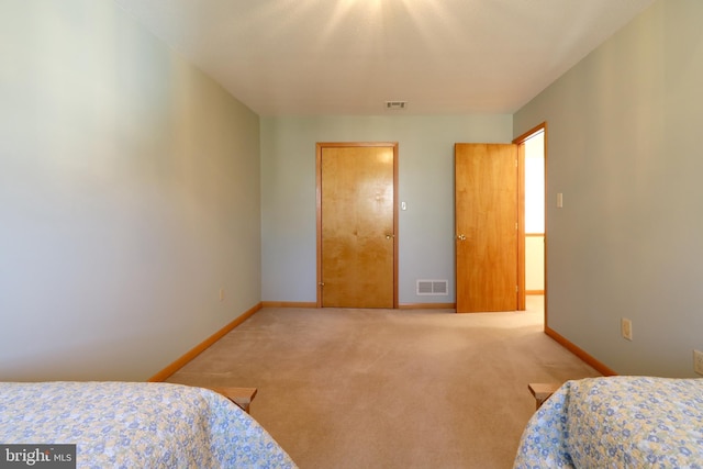 bedroom with light colored carpet