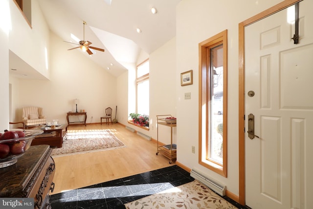 entrance foyer with ceiling fan, hardwood / wood-style floors, and high vaulted ceiling