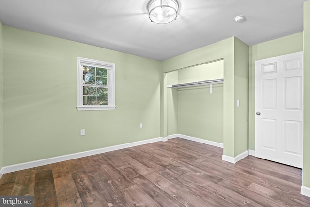 unfurnished bedroom featuring hardwood / wood-style flooring and a closet