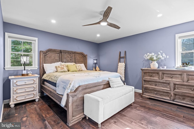 bedroom with multiple windows, dark hardwood / wood-style floors, and ceiling fan