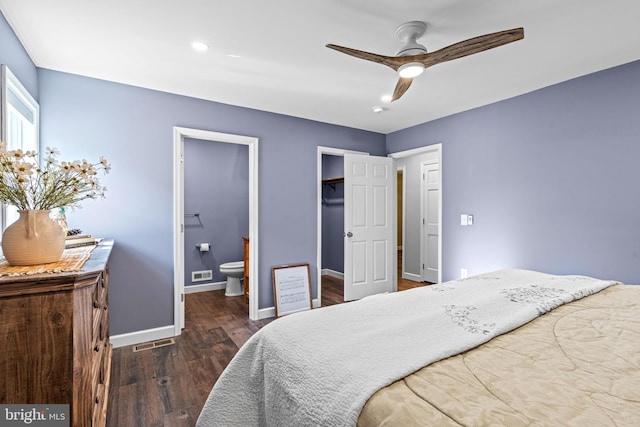 bedroom featuring ensuite bath, ceiling fan, dark hardwood / wood-style flooring, a walk in closet, and a closet