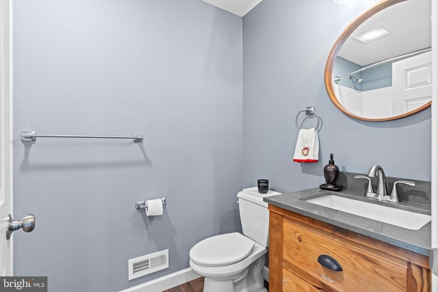 bathroom with vanity, wood-type flooring, and toilet