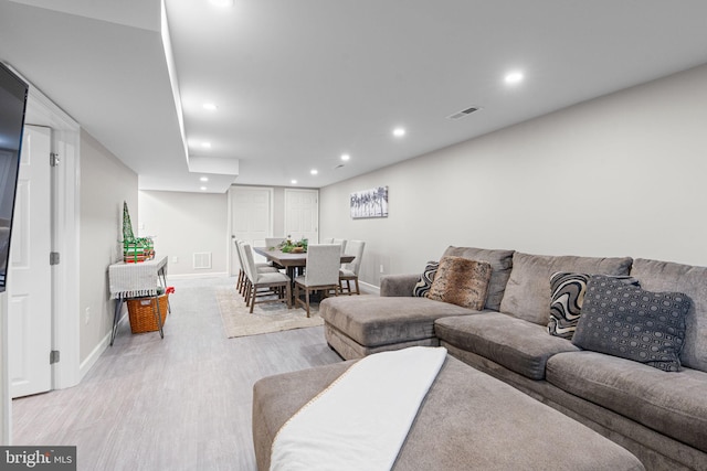 living room with light hardwood / wood-style flooring