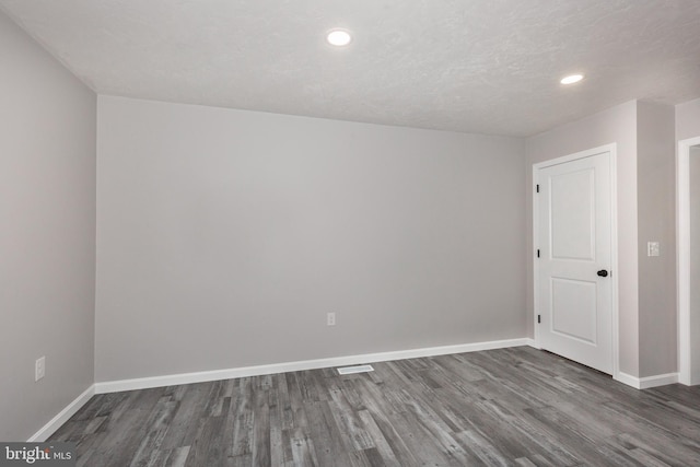 empty room with visible vents, baseboards, wood finished floors, and recessed lighting
