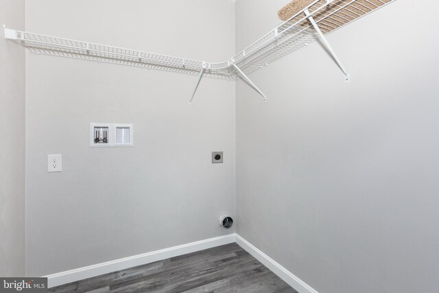 washroom with hookup for a washing machine, electric dryer hookup, laundry area, baseboards, and dark wood-style floors