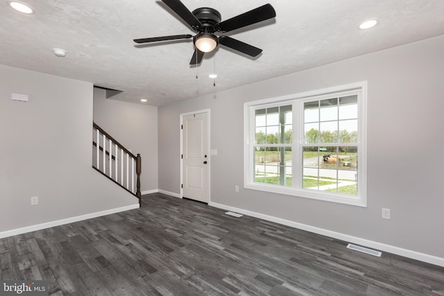 entrance foyer featuring baseboards, stairs, and dark wood-style floors