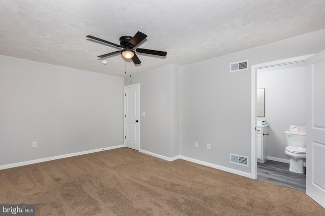 unfurnished bedroom with baseboards, visible vents, and carpet
