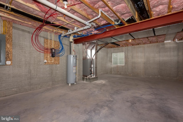 below grade area featuring water heater, heating unit, and electric panel