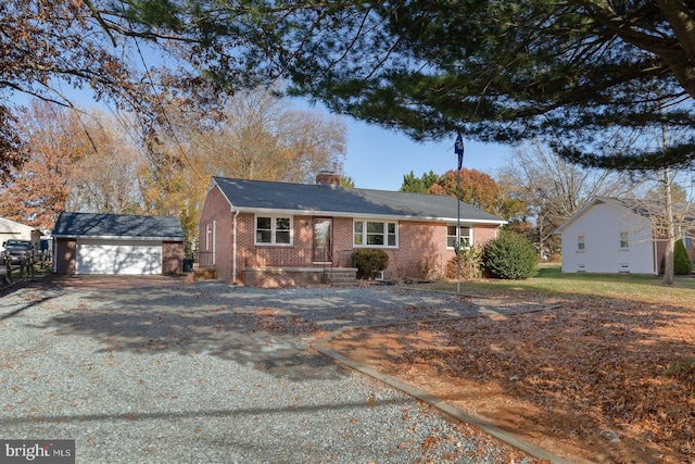 single story home featuring an outdoor structure and a garage