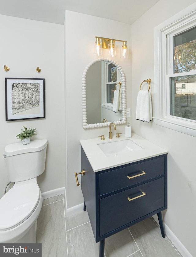 bathroom featuring vanity and toilet