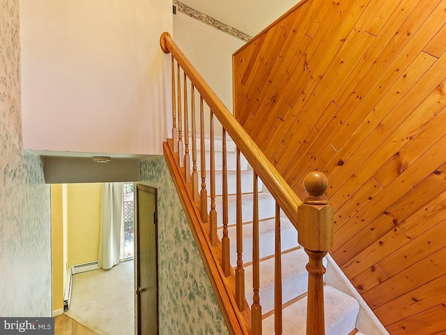 stairs featuring wood ceiling and a baseboard radiator