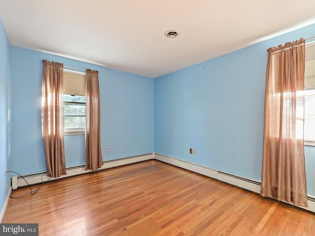 unfurnished room with light wood-type flooring