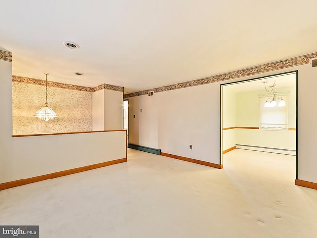 unfurnished room featuring a chandelier and baseboard heating