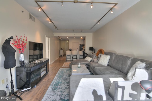 living room featuring hardwood / wood-style floors and rail lighting