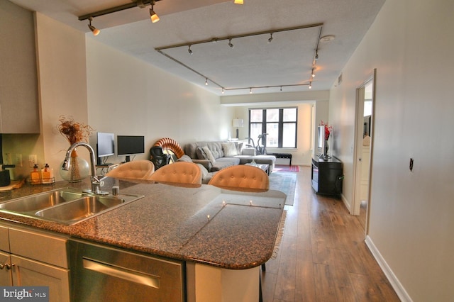 400 Massachusetts Ave NW Unit 423, Washington, DC 20001 - kitchen with a sink, rail lighting, open floor plan, and hardwood / wood-style floors