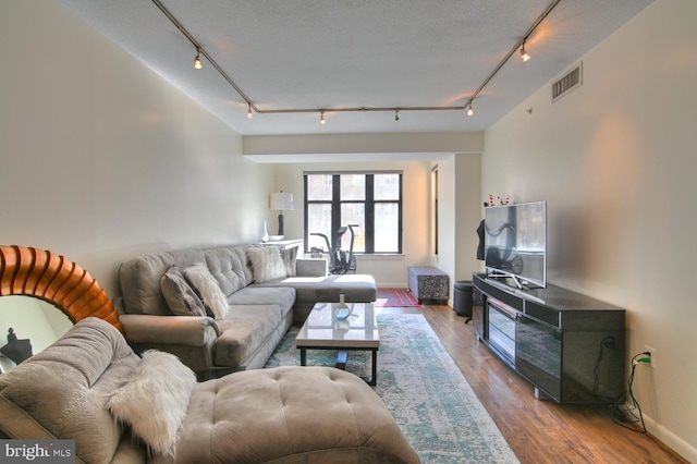 400 Massachusetts Ave NW Unit 423, Washington, DC 20001 - living area featuring rail lighting, wood finished floors, and baseboards