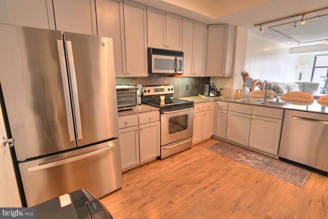 400 Massachusetts Ave NW Unit 423, Washington, DC 20001 - kitchen with stainless steel appliances, light wood-style flooring, rail lighting, and a sink