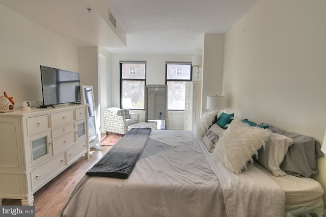 bedroom with hardwood / wood-style flooring