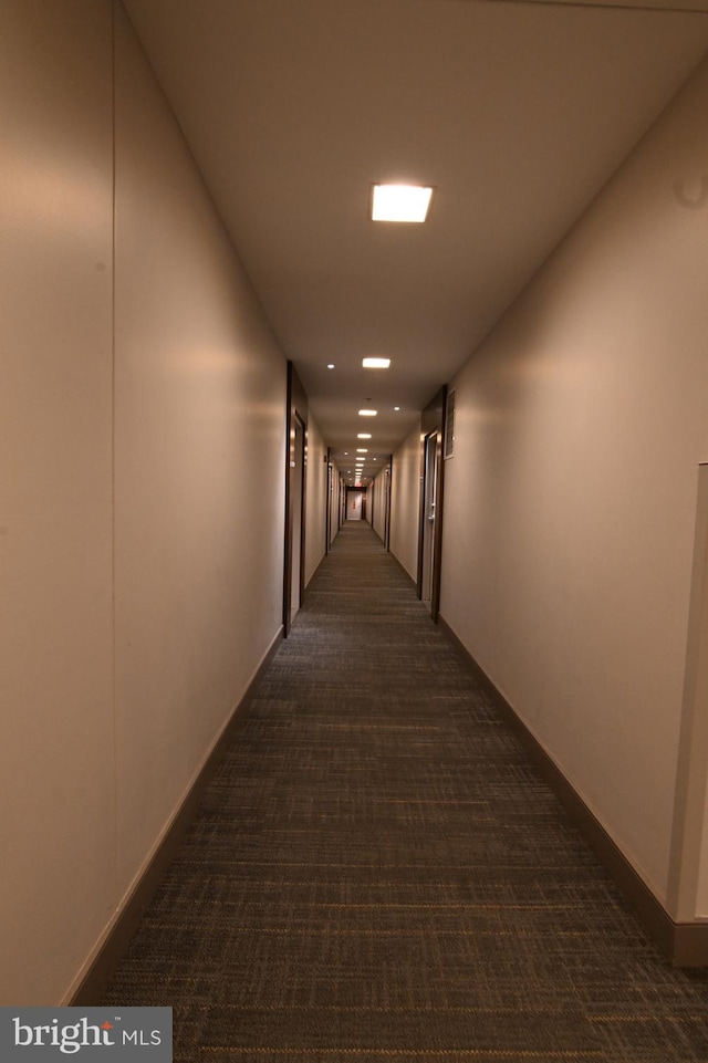 hallway with dark carpet