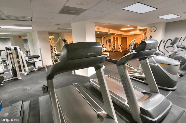 workout area with a paneled ceiling