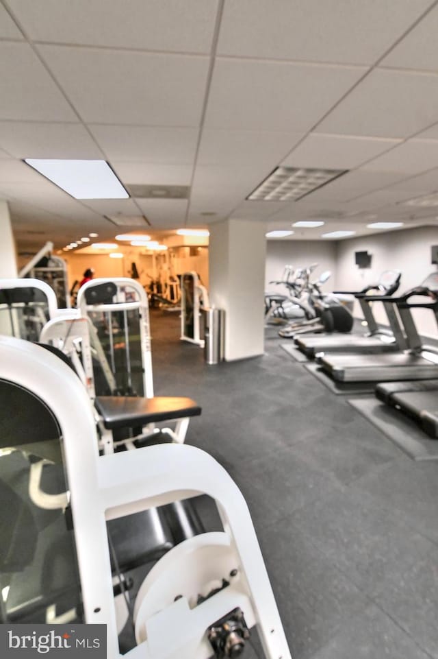 workout area featuring a paneled ceiling