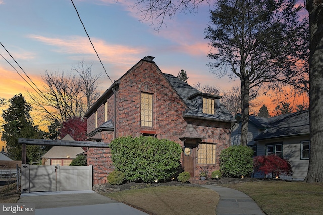 english style home with a yard