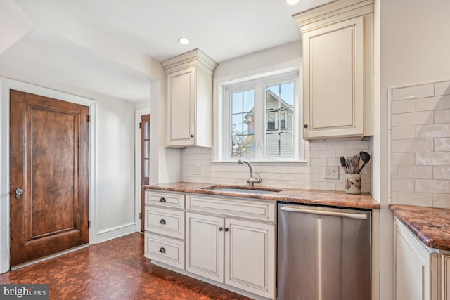 kitchen featuring dishwasher, backsplash, stone countertops, and sink