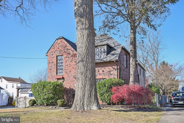 english style home with a front lawn