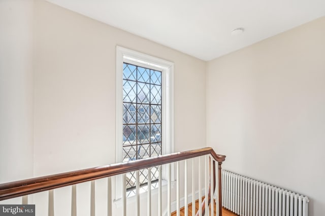 stairway with radiator and wood-type flooring