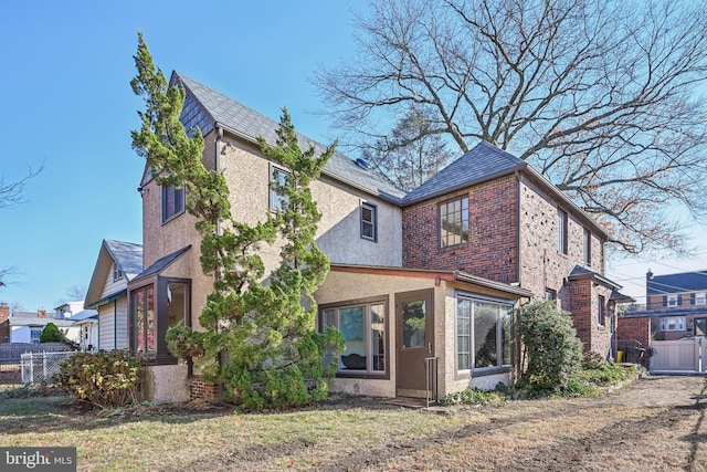 rear view of property with a yard