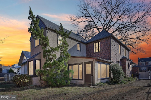 view of back house at dusk