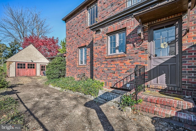 view of home's exterior with a garage and an outbuilding