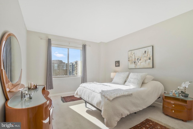 bedroom featuring light carpet