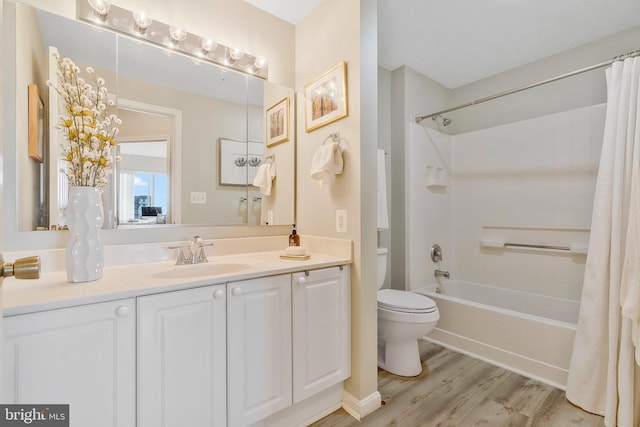 full bathroom featuring shower / tub combo with curtain, vanity, wood-type flooring, and toilet