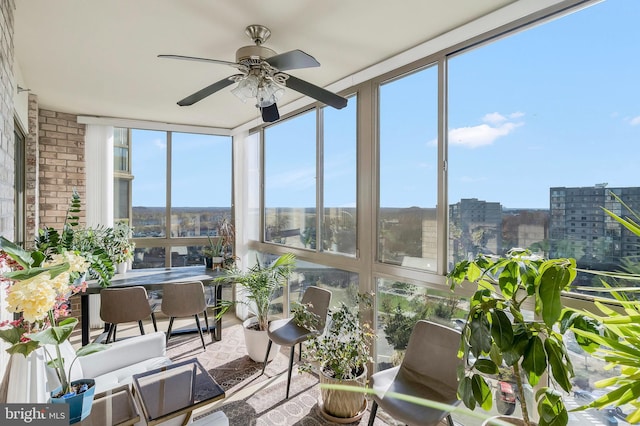 sunroom featuring ceiling fan