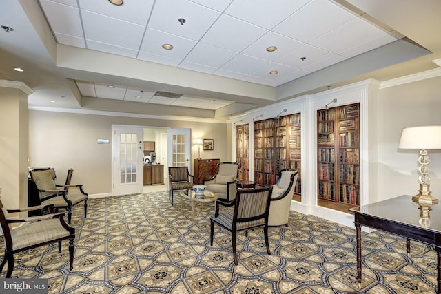 interior space with a tray ceiling, french doors, and ornamental molding