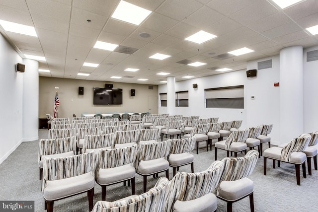 home theater with carpet and a paneled ceiling