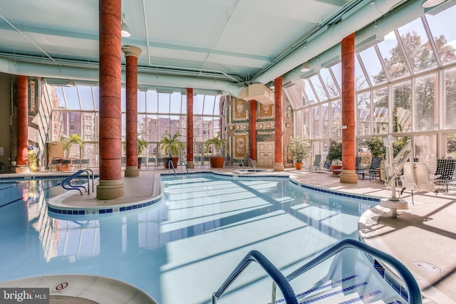 view of swimming pool with a patio area and a lanai