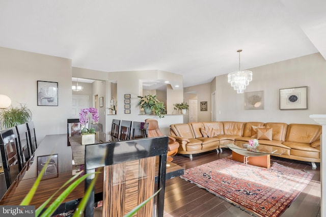 living room featuring a notable chandelier and dark hardwood / wood-style floors