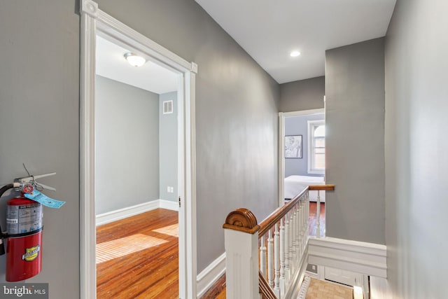 hallway with light hardwood / wood-style flooring