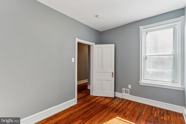 spare room featuring dark hardwood / wood-style floors