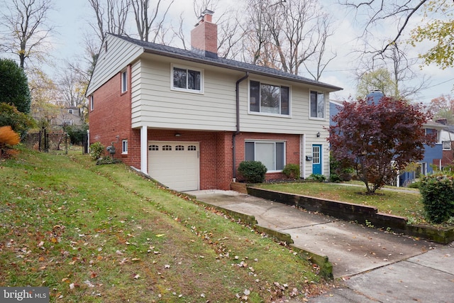 view of front of property with a front lawn and a garage