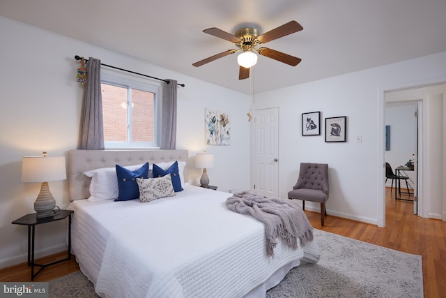 bedroom with hardwood / wood-style floors and ceiling fan