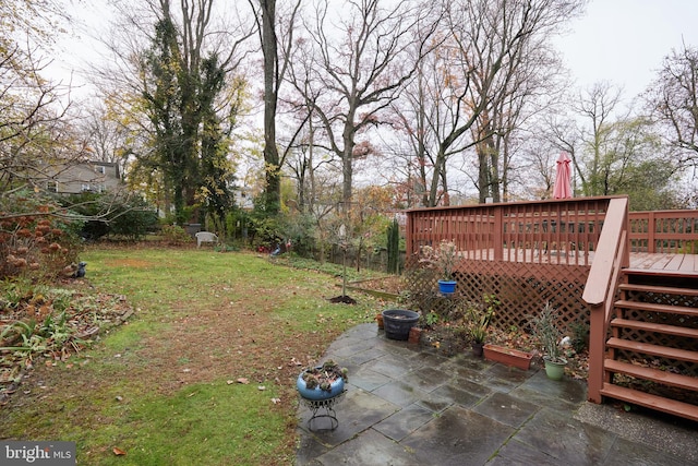 view of yard featuring a deck and a patio area