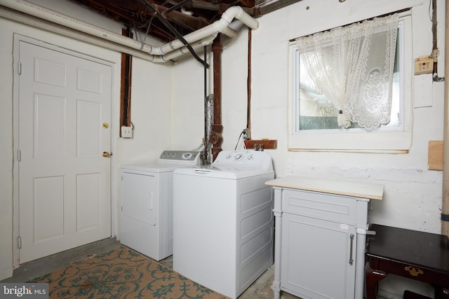 laundry room featuring cabinets and washer and dryer