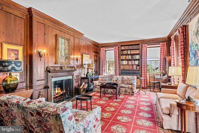 living room with wooden walls and ornamental molding