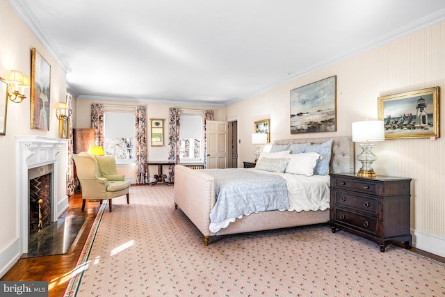 bedroom with ornamental molding, a fireplace, and light hardwood / wood-style flooring