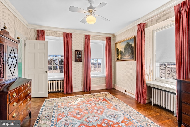 interior space featuring ornamental molding, radiator heating unit, ceiling fan, and dark hardwood / wood-style flooring