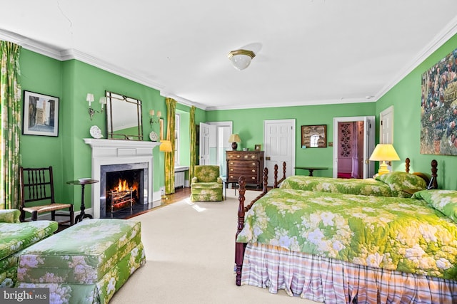 bedroom featuring ornamental molding and carpet floors