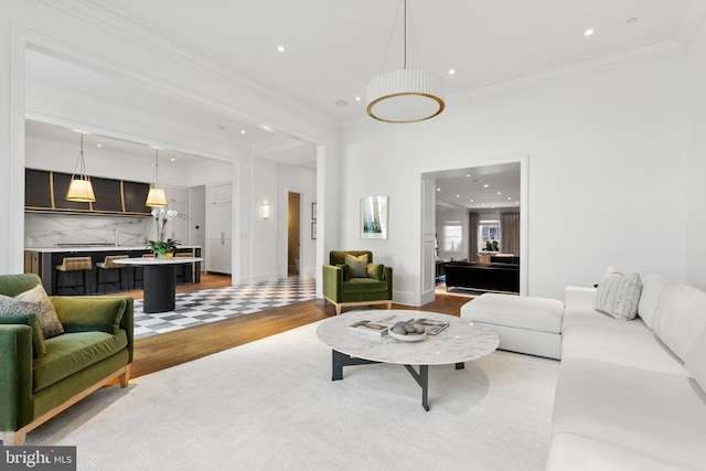 living room featuring hardwood / wood-style flooring and ornamental molding